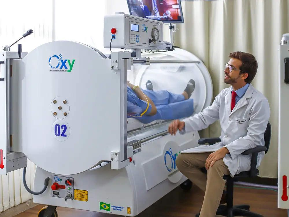 Médico da BMH ao lado da câmara monoplace na unidade Asa Sul